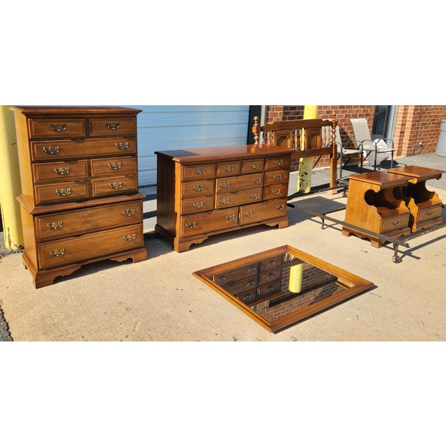 Queen bedroom set with warm honey-brown finish and traditional Colonial-inspired styling, featuring a spindle-and-panel...