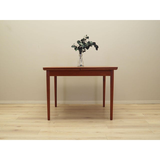 The table was made in the 1970s, Danish production. The structure and the table top are covered with teak veneer. The legs...