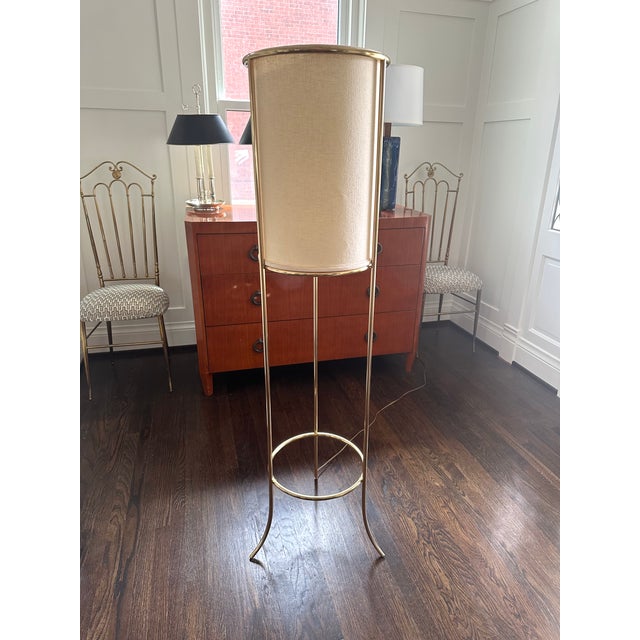 Distinctive tripod brass floor lamp designed by T.H. Robsjohn-Gibbings, style #215, manufactured by Hansen and retailed...