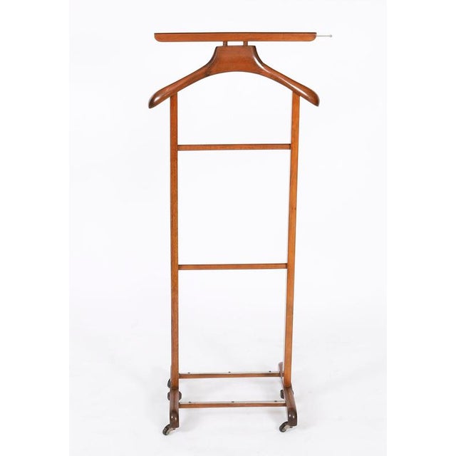 This is an elegant English Edwardian revival walnut gentleman's valet/clothes stand dating from the mid 20th century. The...