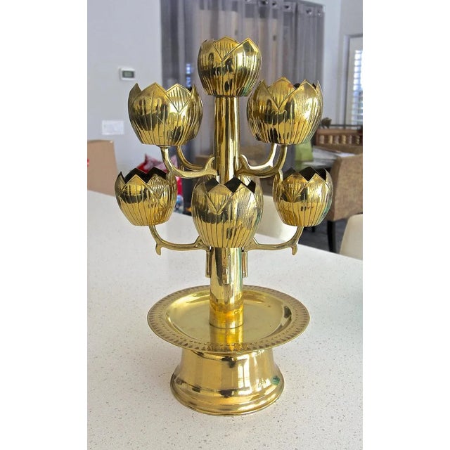 A brass lotus flower 9 cup candle holder or candelabra, attributed to Feldman Lighting Company. Designed to hold votive...