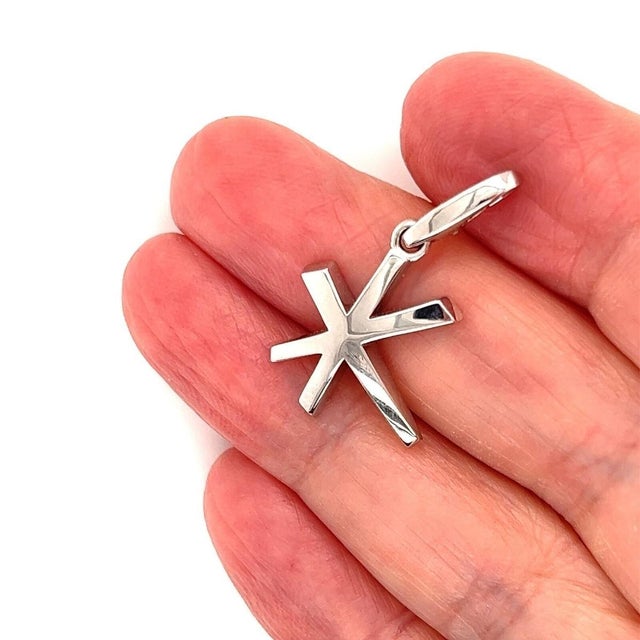 The Cartier 18k White Gold Star Charm Pendant is a luxurious and stylish piece of fine jewelry. As a signed original...