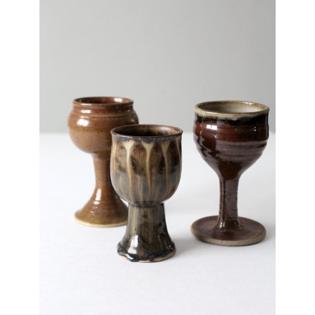 This is a set of 3 vintage studio pottery chalices. Crafted by three different artists, the handmade collection of ceramic...