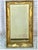French Empire Giltwood and Gesso Overmantel Mirror. Mirror is crafted in carved wood with a gesso ground and original gilt...