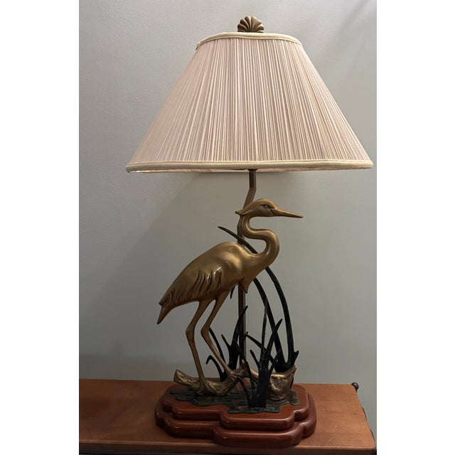 Stunning satin solid brass standing crane in its element. This gorgeous lamp features a calm crane partly hidden in the...