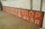 Reclaimed movie set sign made of aluminum in yellow, red, and white colors. The sign reads "Modern Economy Shop,...