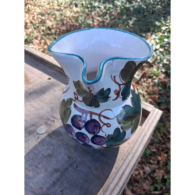 Enjoy this white hand thrown pitchef with hand painted grape leaves. Marked with a number and Italy on the base. Unknown...