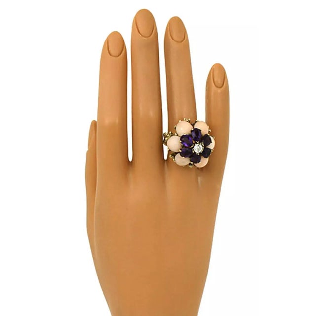 This gorgeous estate ring is crafted from 18k yellow gold with a fancy open design band, the high shank has angel skin...