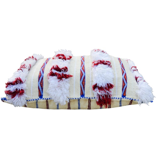 Handwoven Moroccan Berber wedding pillow from the High Atlas Mountains. Features alternating stripes of wool fringe,...