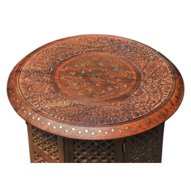 Antique Middle Eastern Circular Carved Table with Repetitive Brass Floral Patterns. Arabesque Tabletop Has A Central...