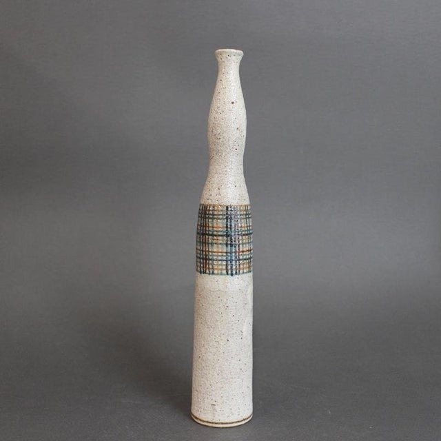 Vintage ceramic bottle / single-flower vase by Bruno Gambone (circa 1970s), of a slender, elongated silhouette rising from...