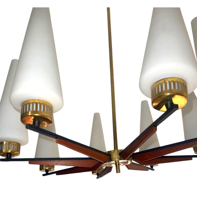 An elegant eight-light uplight chandelier designed by Stilnovo, Italy, circa 1950s. This refined Mid-Century Modern...