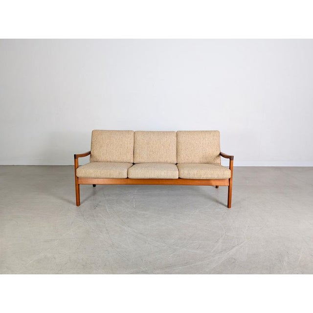 Beautiful teak three-seater sofa by France & Son from the 1960s. This piece of furniture impresses with its minimalist...