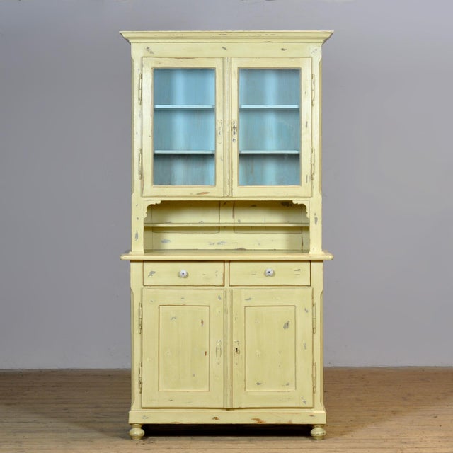 Large pine cupboard from circa 1920, finished in the original paint with a beautiful, weathered patina. This authentic...