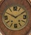 French Art Deco Oval Mahogany and Brass Wall Clock, the brass face with Arabic numerals and dash indices, surround by...