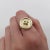 This 14k gold button ring has a cool three dimensional ridge, and gold threading as the focal point in the center. The...
