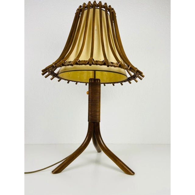 A wonderful teak table lamp made in the 1960s. It is fascinating with its rare lamp shade. The light requires two e27 (us...