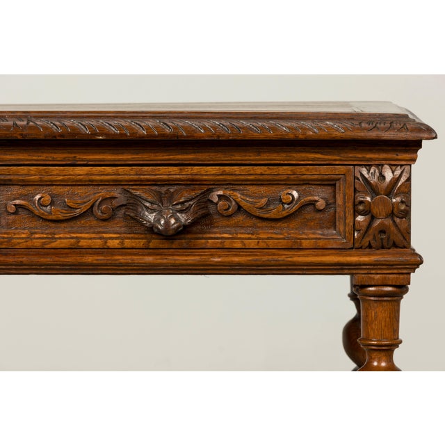Handsome late 19th century French oak writing desk in the Henry II style, sourced in Provence, France. Crafted in solid...