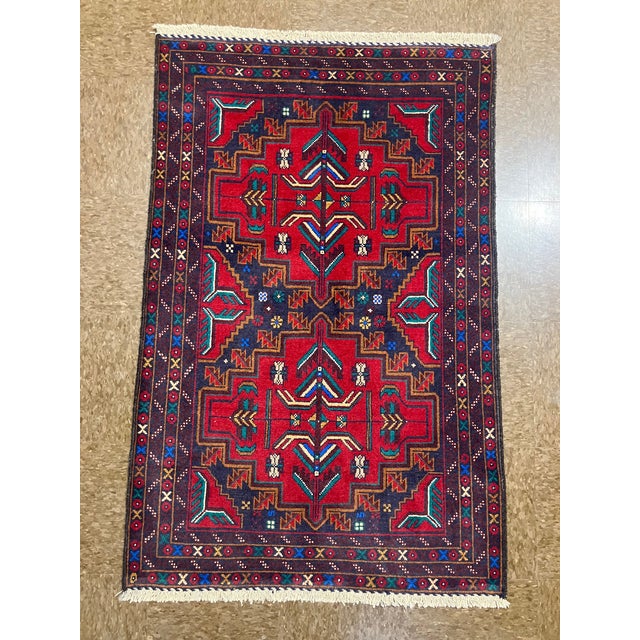 Hand-knotted Baluch rug, traditionally woven by tribal groups of eastern Iran and Afghanistan. Features a bold geometric...