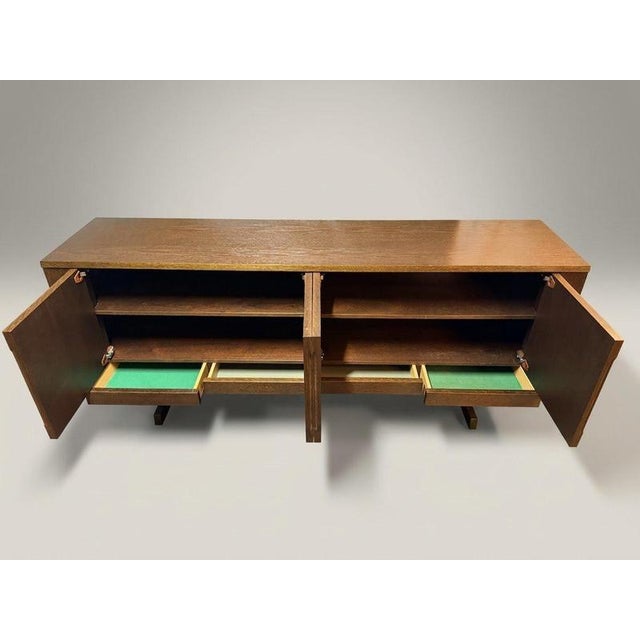 A monumental danish stained oak sideboard attributed to skovby furniture makers, defined by its commanding presence and...
