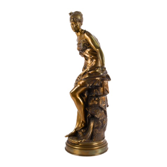 Graceful and timeless, this antique bronze figural sculpture attributed to De Broussé captures the elegance and refinement...