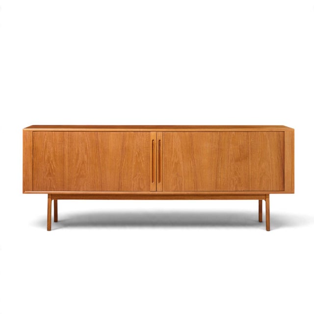 Svend Aage Larsen for Faarup Møbelfabrik Mid Century Danish Teak Tambour Door Credenza This credenza measures: 78.75 wide...