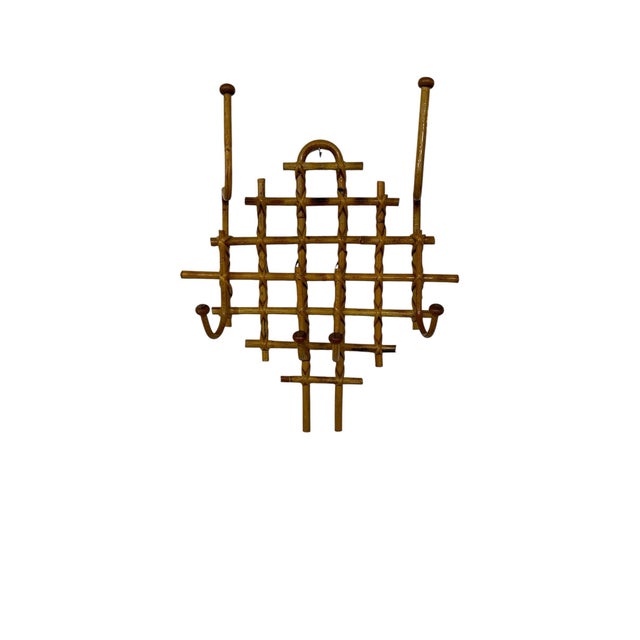 Vintage bamboo and rattan coat, hat rack. Measures 17” w x 7” d x 21” h. Displays well with almost any style.