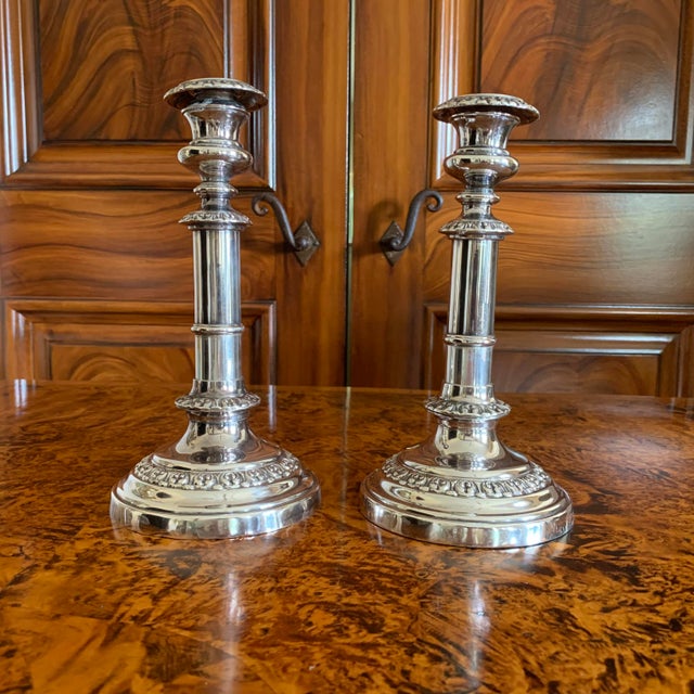 A pair of traditional Georgian style silver on copper candlesticks with repousseé acanthus moulding and straight columnar...