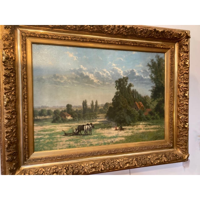 A large, beautifully atmospheric pastoral landscape by Belgian painter Guillaume Lauters (1845–1937), depicting a tranquil...