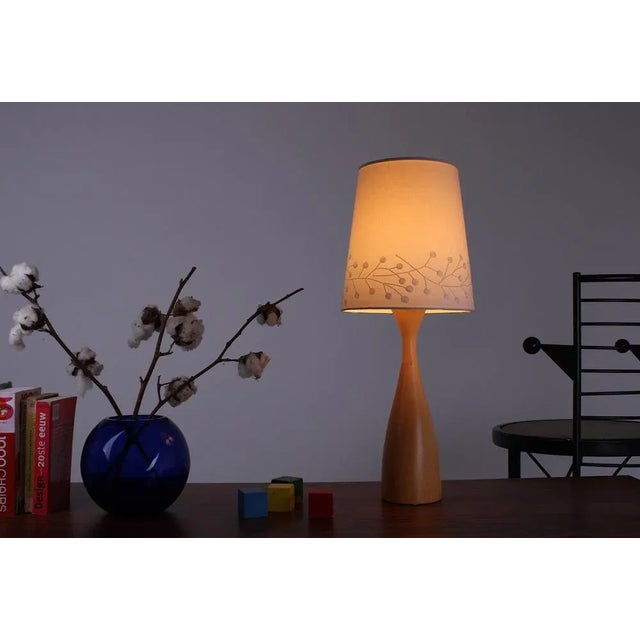 Very elegant slender bedside/table lamp by Ikea. Featuring a soft fabric lampshade decorated with a delicate floral motif,...