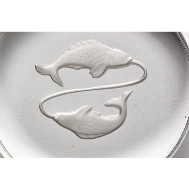 Dreamy engraved round glass disc Pisces paperweight by Val Saint Lambert, France, circa 1970s. Signed with engraved...