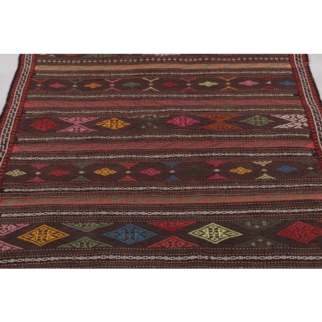 Made with handwoven wool circa 1950-1960, this 4x6 vintage Persian Kilim, originating from the Larkhabi region of...