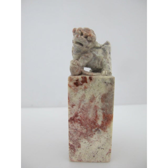 Chinese hand-carved Shoushan soapstone miniature chop seal featuring a foo dog finial atop a mottled red and gray...