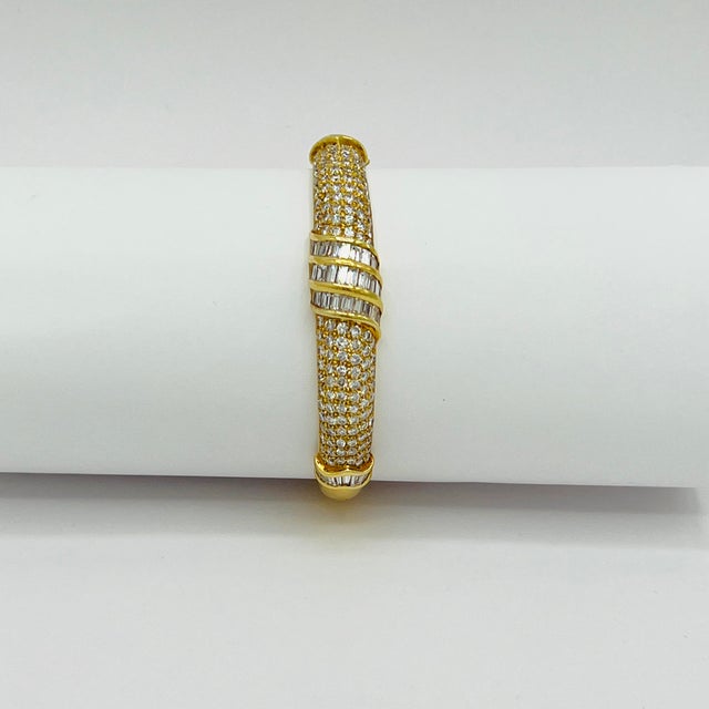 Beautiful 5.00 ct. good quality white diamond rounds and baguettes. Handmade in 18k yellow gold. This bangle is perfect...