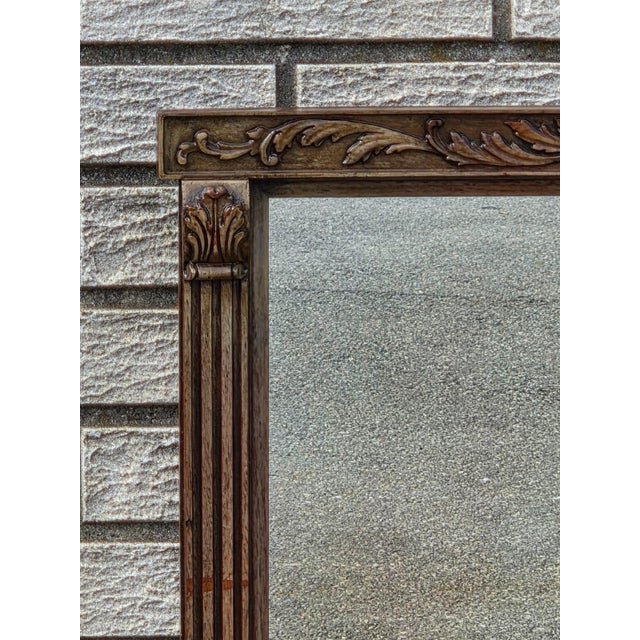 The product is a 1920 regency style walnut mirror, featuring a rectangular shape with a brown color and a mirrored frame...