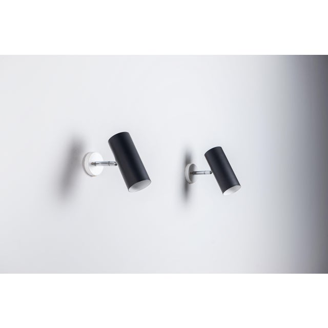 This elegant pair of Raak C1582 adjustable wall lamps combines timeless Dutch design with everyday functionality. In good...