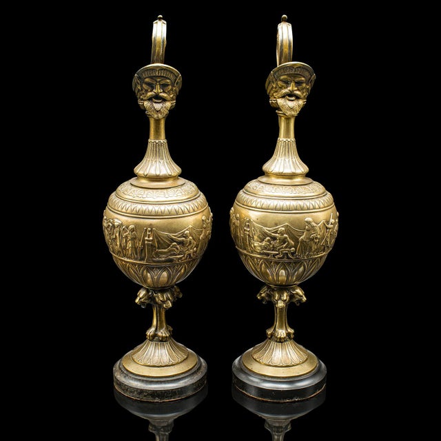 This is a pair of antique ornamental ewers. An Italian, bronze Grand Tour decorative pourer with classical taste, dating...