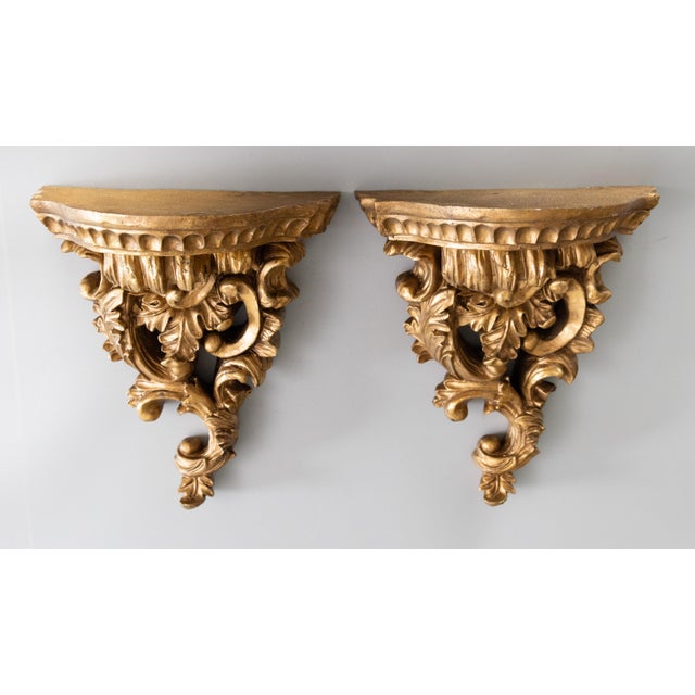 A lovely pair of vintage Rococo style Italian gilded resin wall brackets or shelves. These gorgeous brackets are a nice...