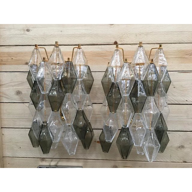 A pair of 2 Murano Glass "poliedri " wall sconce with a gold 24 karat metal frame, a pair Spare parts included. 2 bulbs....