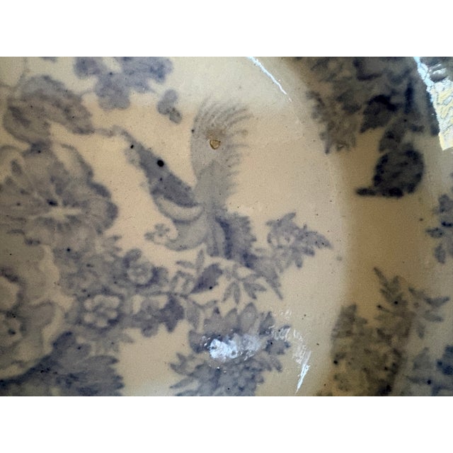 An antique oval serving platter featuring the classic blue Asiatic Pheasant patter of transfer ware. These pieces were...