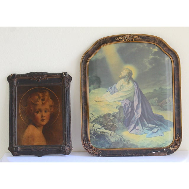 A beautifully evocative pair of early 20th-century religious portraits, this antique devotional set presents two distinct...