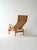 Iconic 'Pernilla' armchair by Bruno Mathsson, with curved wooden structure and woven seat, complete with matching...