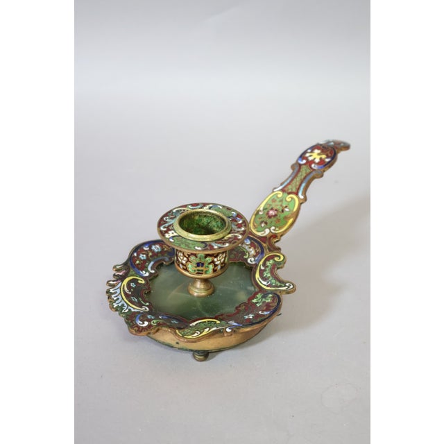 A late 19th-century French chamberstick in gilt brass, richly decorated with champlevé enamel and set with a green onyx...