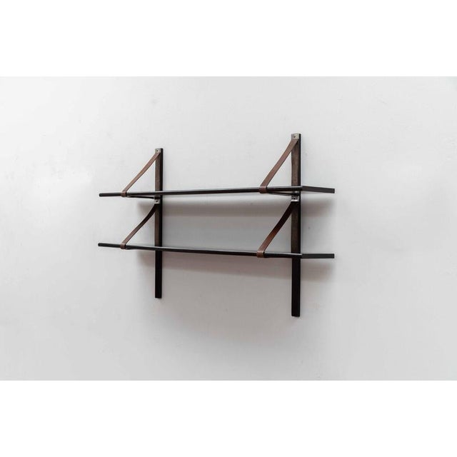 These leather-strap wall shelves were designed by Spanish industrial designer Miquel Mila in 1962, this original edition...