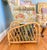 Simple and modern vintage asymmetrical Hollywood Regency style bent burnt bamboo magazine rack. This piece is a great...