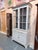 A refined Gustavian style display cabinet attributed to K.A. Roos of Helsingborg, showcasing a beautifully muted painted...