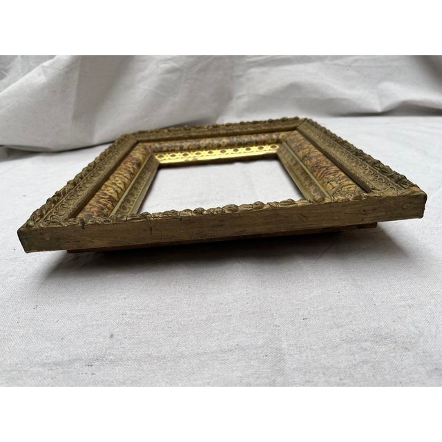 A single rectangle shape wood picture or mirror frame featuring applied decoration including gold gesso relief, faux wood...
