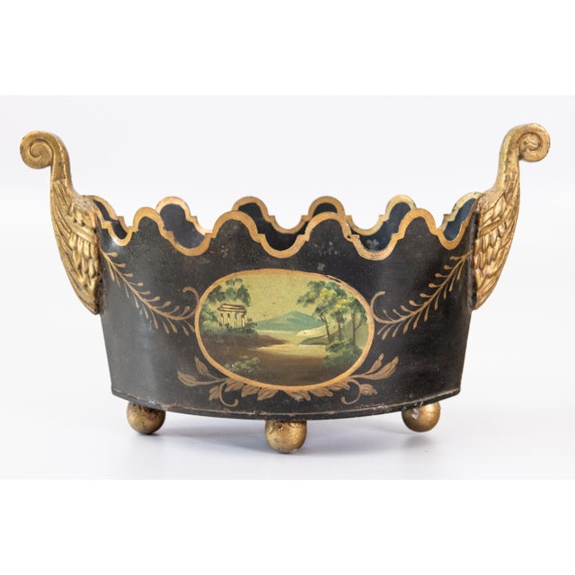 A gorgeous gilded antique French Neoclassical style black and gold toleware monteith cachepot. This fine jardiniere has a...