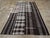 A vintage Turkish flatweave Kilim long and narrow room size carpet in charcoal black, grey, and cream-white, handmade...