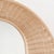 Large round mirror with a sculptural, woven rattan frame forming a basket, which can be hung vertically or horizontally....